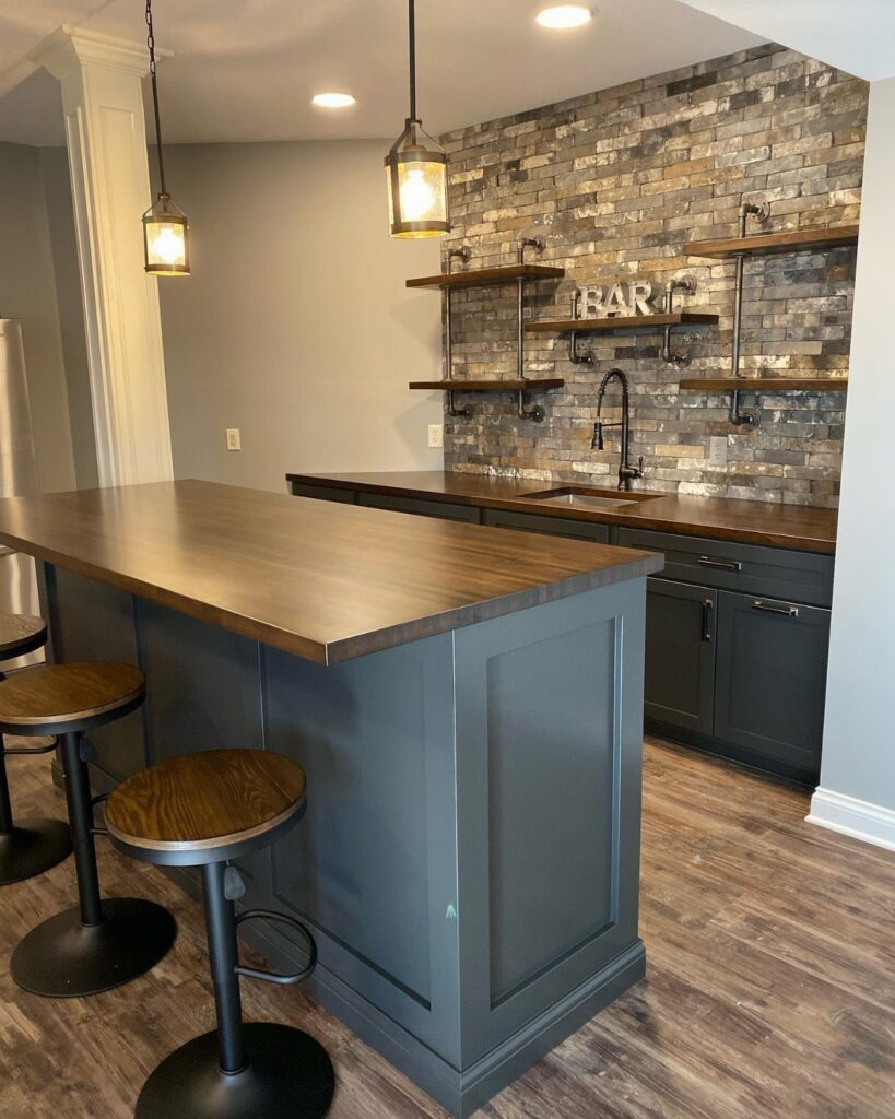 Dark grey cabinets under a wooden countertop in a modern home bar setting.