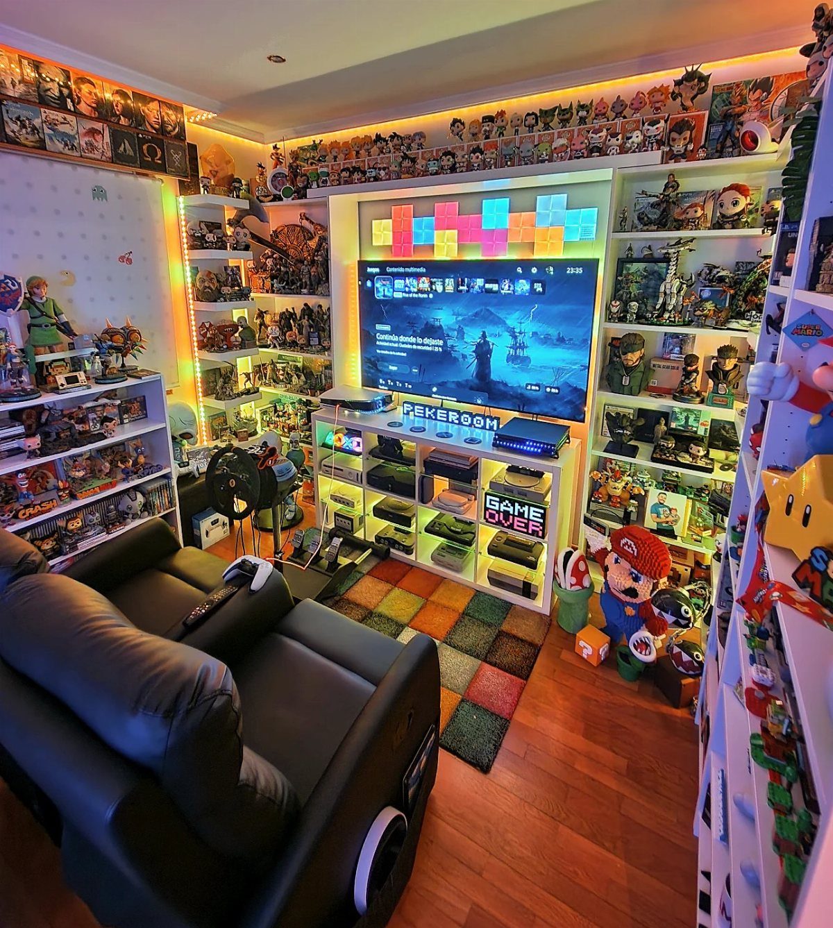 Gaming room with a large TV, leather sofa, and shelves of collectibles.