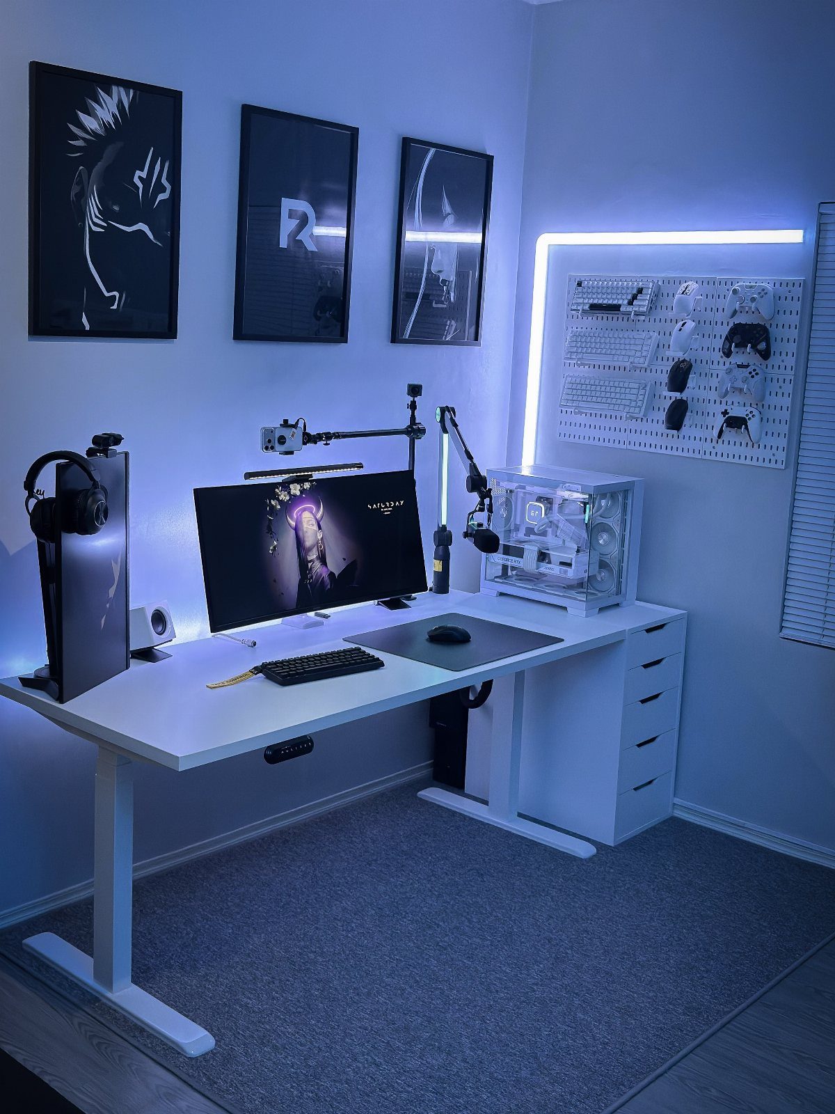 White ergonomic gaming desk with PC setup and blue RGB lighting in a room.