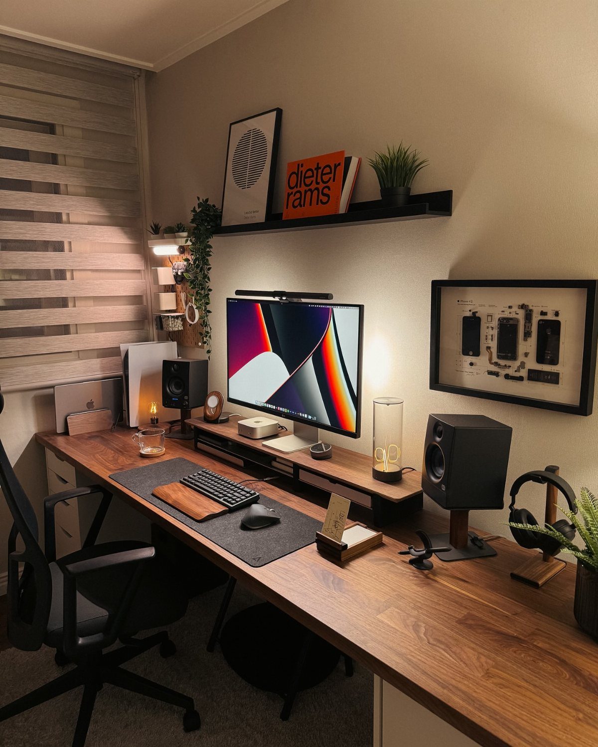 Wooden desk with computer monitor, speakers, and office chair in a modern room