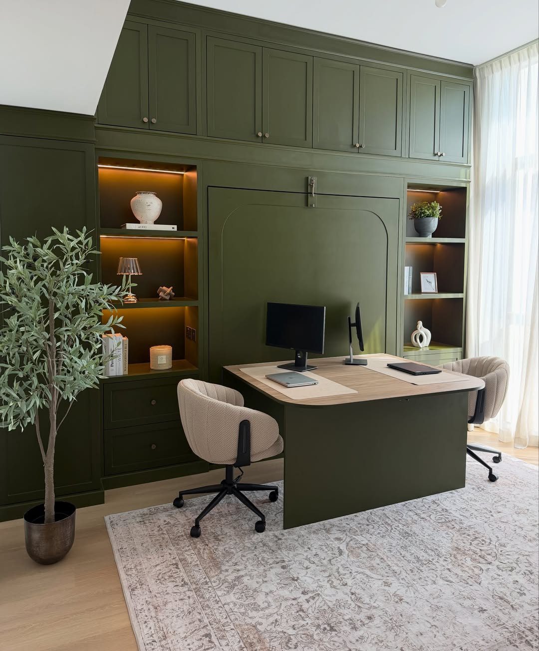 Dark green built-in wall unit with a fold-down desk and integrated shelving.