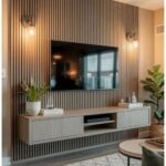 Wood slat feature wall with a mounted TV and floating grey console cabinet.